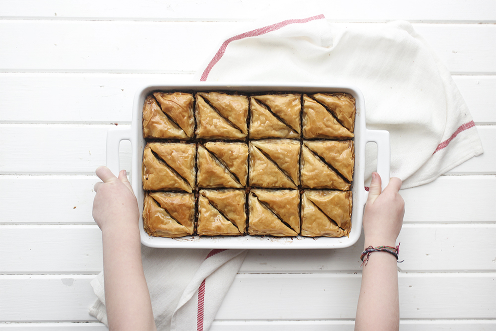 Chocolate Hazelnut Baklava - Flaky, crispy phyllo dough layered with hazelnuts and bittersweet chocolate chocolate, topped with a honey-cocoa nib syrup that provides a twist on the traditional walnut/almond greek baklava dish #baklava #dessert #dessertrecipe #sweetdessert #phyllodough #phyllo #hazelnut #chocolate 