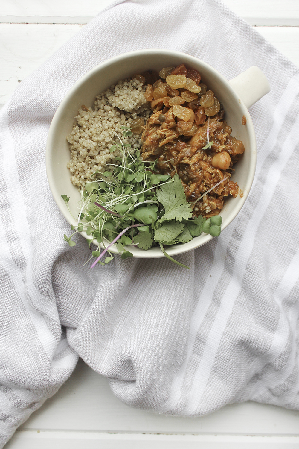 Moroccan Chicken Chickpea Stew - A flavourful one pot meal that everyone in your family will enjoy. Serve Moroccan Chickpea Stew with raisins, greens, yogurt, sliced almonds and quinoa. #onepotmeal #slowcooker #moroccan #chickpea #spices #easydinner #quinoa #vegetarianoption #stew