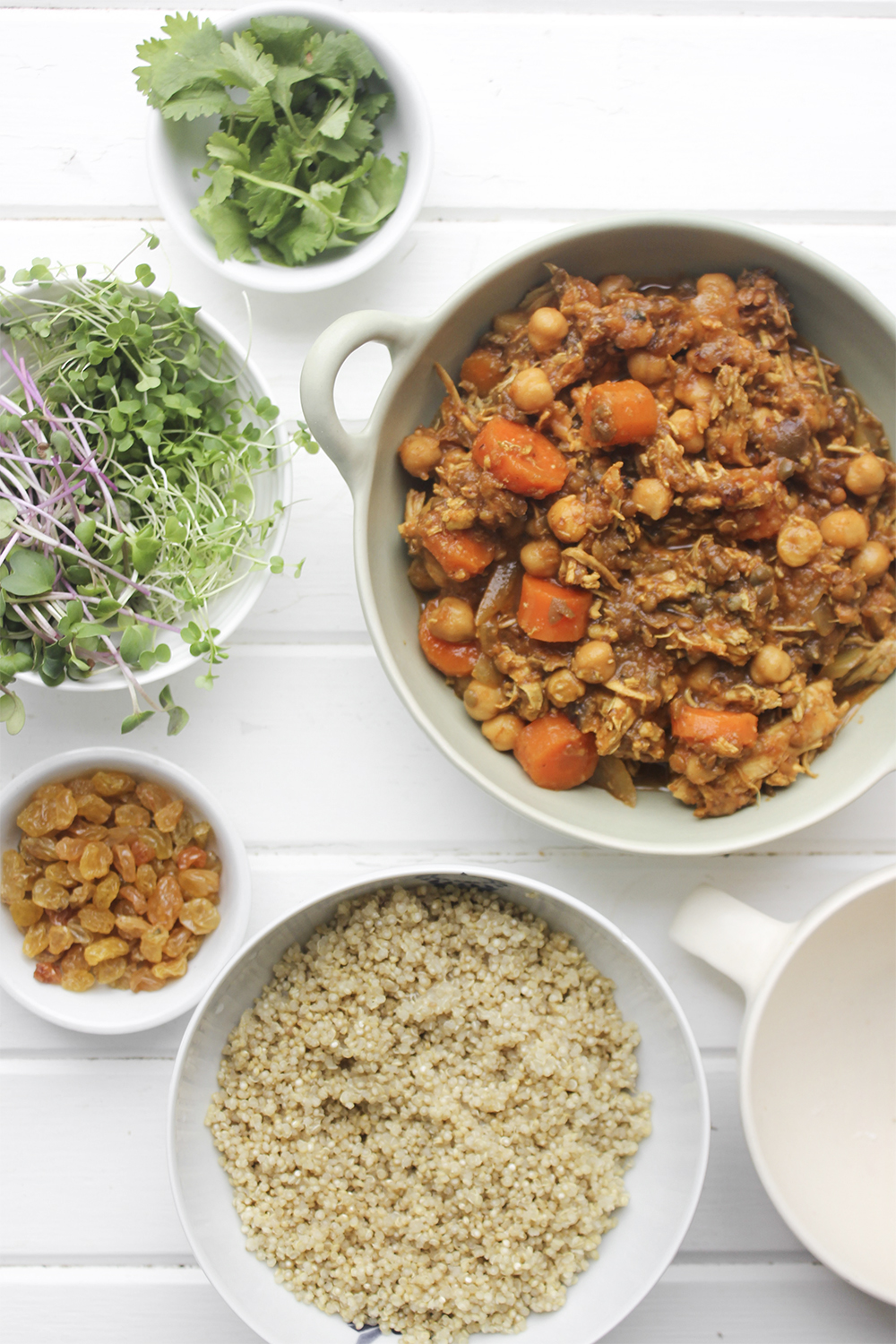 Moroccan Chicken Chickpea Stew - A flavourful one pot meal that everyone in your family will enjoy. Serve Moroccan Chickpea Stew with raisins, greens, yogurt, sliced almonds and quinoa. #onepotmeal #slowcooker #moroccan #chickpea #spices #easydinner #quinoa #vegetarianoption #stew